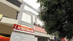 A building with a sign for ICICI Bank and a hotel named Diamond Blue.