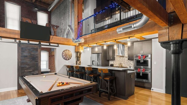 A pool table in a room with a kitchen, bar area, and a loft with a balcony. - Two Story Penthouse - Walk to the Convention Ctr (Indianapolis)
