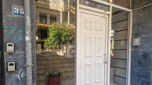 A building entrance with a white door, a mailbox, and a number 35 sign. - N&S Fms, Cozy two bedroom apartment close to Fleming Metro station (Thessaloniki)