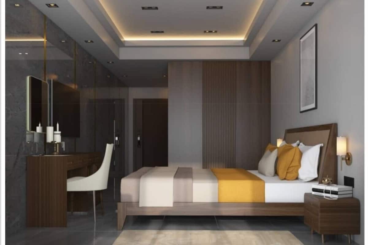 Quarto moderno com cama grande, mesas de cabeceira, escrivaninha e espelho.