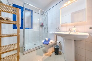 Shower, hair dryer, towels, toilet paper