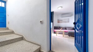 A modern interior with a staircase leading to a living area featuring a sofa and a coffee table. - El rincón de famara - By LVH (Famara)