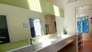 A bathroom with a large mirror, two sinks, and a shower area. - Baan Hinlad Home and Hostel (Koh Samui)