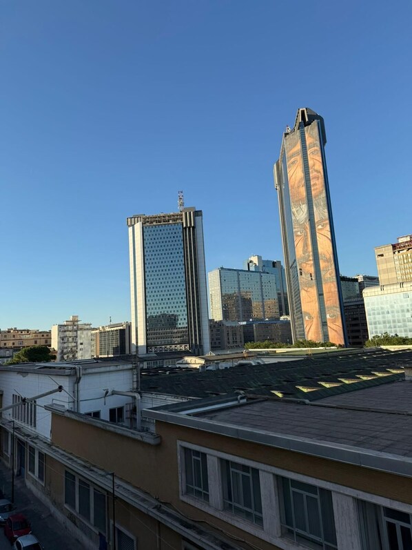 A cityscape with modern high-rise buildings, including a distinctive tower with a patterned facade.