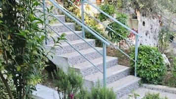 A stone staircase with metal railings leading up to a building.