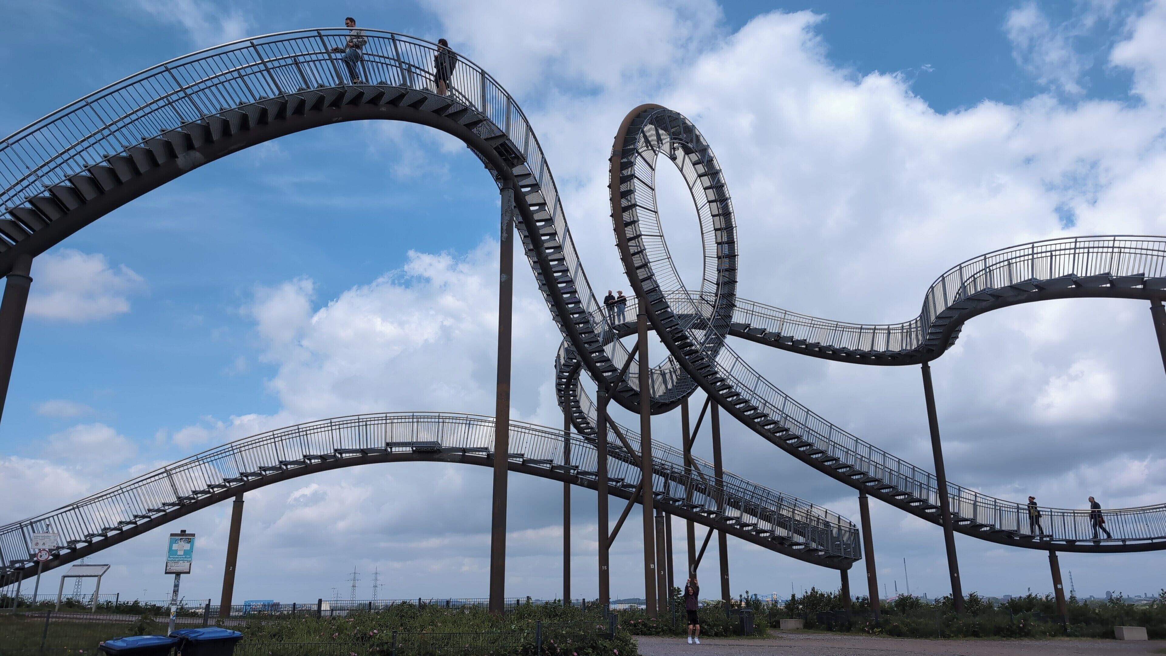 A roller coaster with multiple loops and a clear sky.
