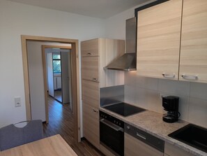 Deluxe Condo, Balcony, Garden View | Private kitchen | Full-sized fridge, oven, stovetop, dishwasher