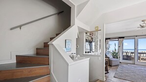 A modern interior with a staircase, a view of the beach, and a balcony. - BAY Views/Community Pool - 1 Port Lewes (Lewes)