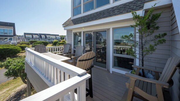 A residential deck with outdoor seating and large windows. - BAY Views/Community Pool - 1 Port Lewes (Lewes)