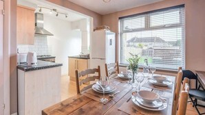 A modern kitchen with a dining area.