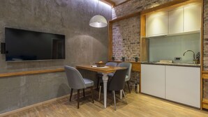 A modern kitchen with a brick wall, wooden beams, and a built-in TV. - Sapphire - Max Luxury Apartments, a Large Apartment in the Belgrade City Center (Beograd)