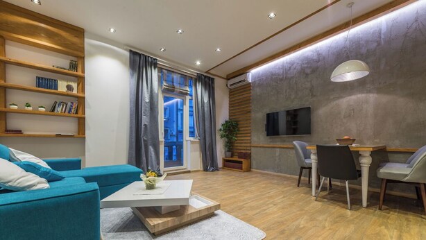 A modern living room with a sofa, coffee table, and dining area. - Sapphire - Max Luxury Apartments, a Large Apartment in the Belgrade City Center (Beograd)