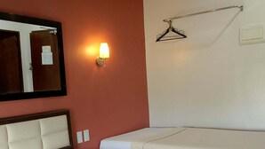 A hotel room with two beds, a large mirror, a wall-mounted light, and a coat rack. - WJV Mia Hotel Humay-Humay (Lapu-Lapu)
