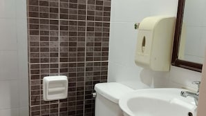 A bathroom with a toilet, sink, and hand dryer. - WJV Mia Hotel Humay-Humay (Lapu-Lapu)