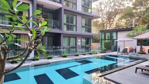 A modern building with a swimming pool, glass railings, and outdoor seating. - A204 - 1 Bdr Condo With Sea View, Ao Nang Beach (Krabi)