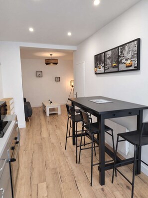 A modern kitchen with wooden cabinets and a built-in oven. - Charming 2-bedroom duplex, tram and free parking (Saint-Jean-de-Védas)