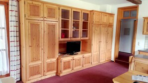 A wooden cabinet with multiple doors and a television on a stand. - Holiday apartment "Hoellfelsen" – 2 Guests (Warmensteinach)