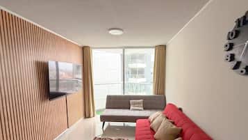 Departamento Confort, balcón, vista parcial al mar | Sala de estar