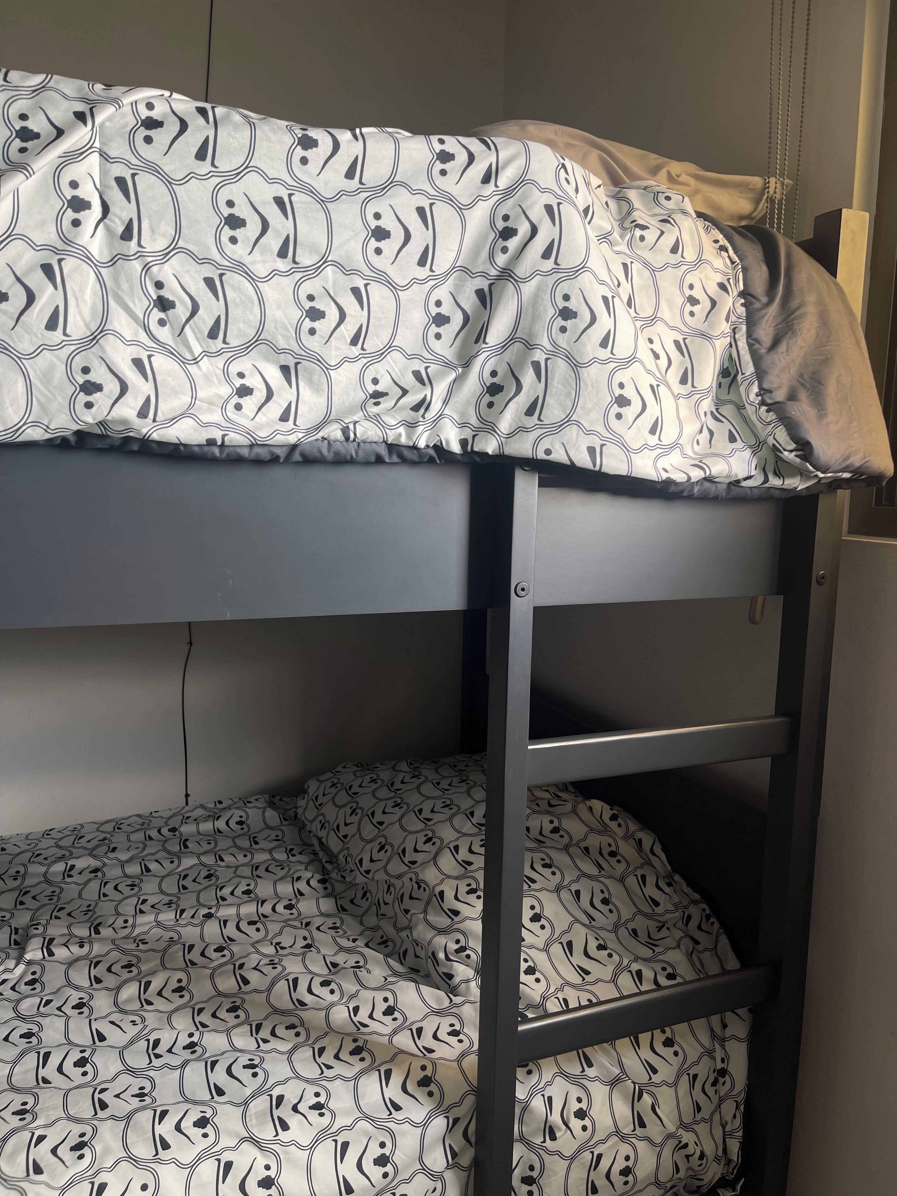 A bunk bed with patterned bedding.