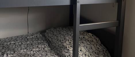 A bunk bed with patterned bedding.
