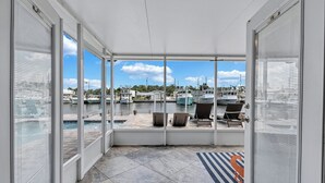 A covered outdoor area with a view of boats and a marina. - Hernando Beach Gulf Access, Dock & Heated Pool (Hernando Beach)