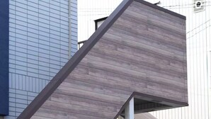 A modern building with a unique staircase design, featuring a combination of wooden and metal elements. - SHIZUKURIA MINAMIGYOTOKU (Ichikawa)