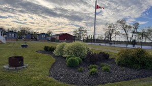 A residential area with houses, a flagpole with a flag, and a sports court.
