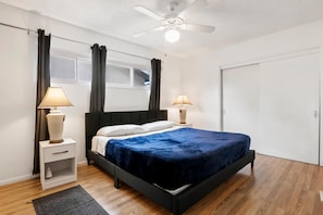 A bedroom with a bed, two bedside tables, a ceiling fan, and a window with curtains. - 5bed 3bath home with piano in Los Angeles by Universal studio & Hollywood-10 (Los Angeles)