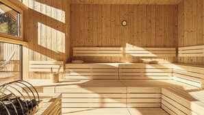 A sauna with wooden benches and a wooden ceiling, a clock on the wall, and a window with a view of trees. - Lärchenlodge SkySpa und Rooftop Pool (Fulpmes)