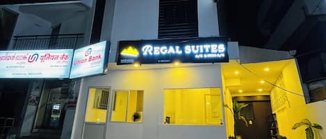 A building with a sign for Regal Suites and a sign for Union Bank of India.