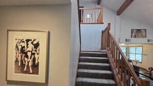 A staircase with a wooden railing leading to an upper level. - Winding Hollow : Spacious 5-bedroom house in tranquil Arlington (Arlington)