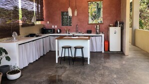 A compact kitchen with a central island, a sink, and a refrigerator. -  Surrounded by beautiful views + 7 min. walk to the beach (Lo de Marcos)