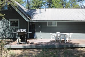 A house with a covered patio, a grill, and outdoor furniture. - Lave Top 1 - Updated Cabin, SHARC, Pet Friendly, Walk to SHARC (Sunriver)