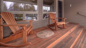 A porch with two rocking chairs and a woven rug. - Lone Eagle Landing 2 - Updated, A/C, Hot Tub, SHARC Passes (Sunriver)