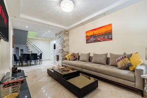 Una sala de estar moderna con un sofá, una mesa de centro y un cuadro en la pared.