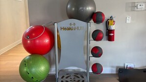 A fitness area with exercise balls and a HealthHub branded equipment.
