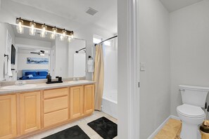 A modern bathroom with a vanity, sink, and toilet. - Spacious Comfort Near DIA (Aurora)