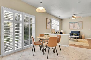 A dining area with a round table, chairs, and a ceiling fan. - Spacious Comfort Near DIA (Aurora)