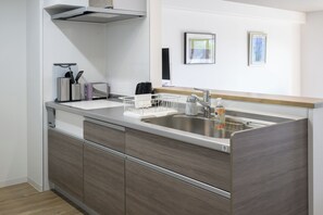 Full-size fridge, microwave, cookware/dishes/utensils