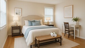 A neatly arranged bedroom with a bed, bedside tables, a desk, and a chair. - SAUNA IS TEMPORARILY OUT OF SERVICE . (Norwich)