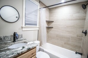 Shower, hair dryer, towels, toilet paper
