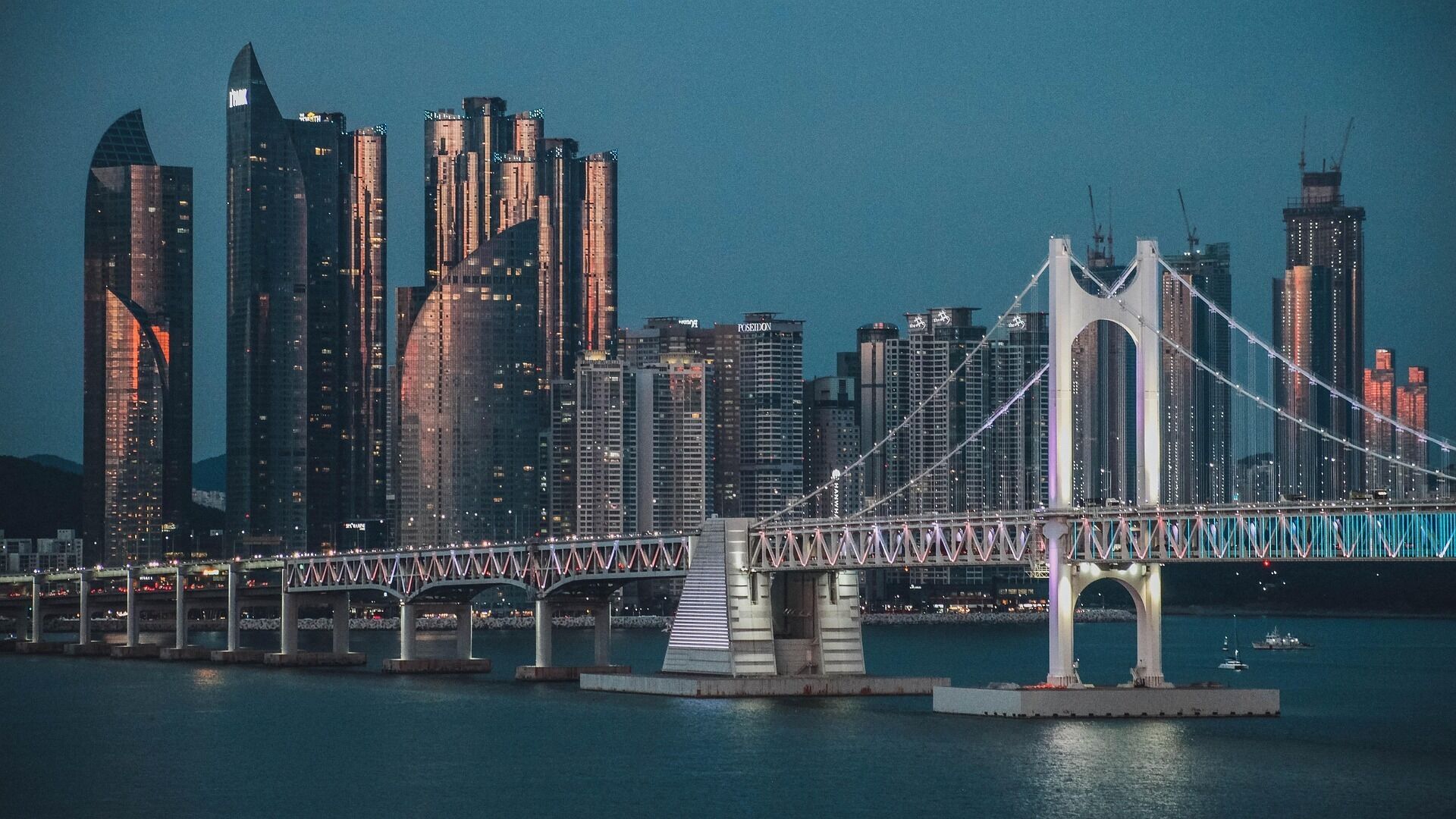 A bridge with a city skyline in the background.