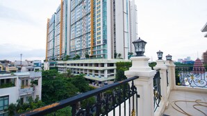 A high-rise building with multiple balconies and a gated entrance. - Van Loi Home (Ho Chi Minh City)