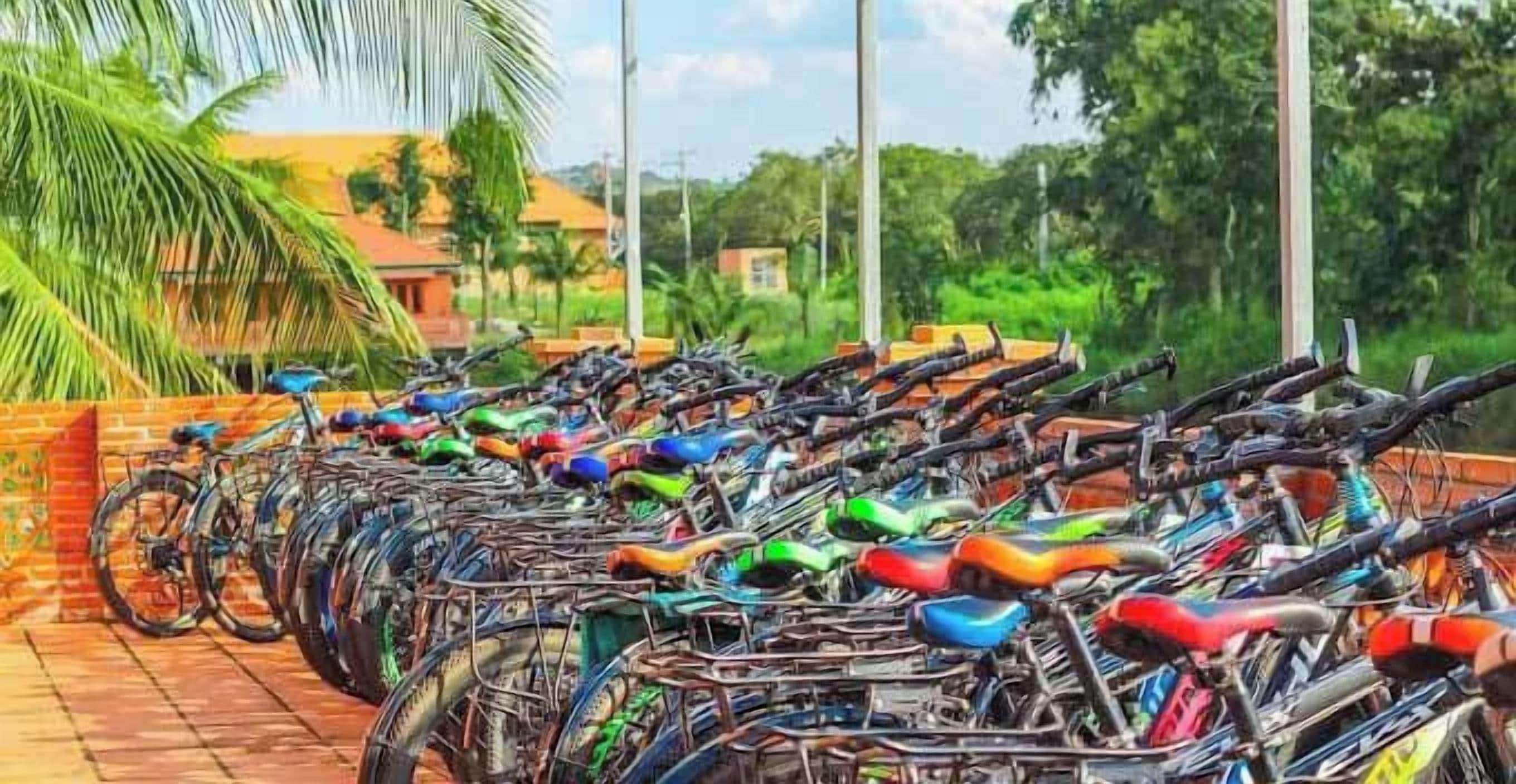 A row of bicycles parked on a brick surface, with a logo of 'Orchard Home' visible.