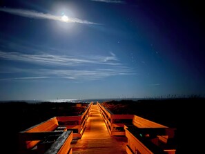 A wooden boardwalk leading to a beach at night with a full moon in the sky. - Fall & Holiday Deals! NEWLY Remodeled Oceanside Townhouse!!! Pets Pools Bikes! (St. Augustine)