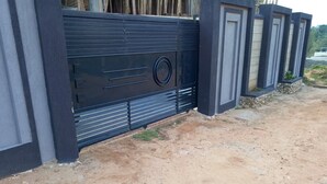 A modern building with a black metal gate and a concrete pathway. - Sophie's Garden Hotel Kapenguria (Makutano)
