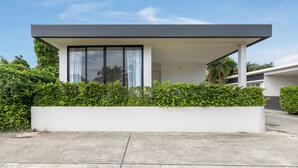 A modern house with a flat roof, large windows, and a covered patio area. - Villa Noa  Modern 2BR with Private Pool (Rawai)