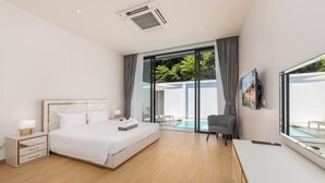 A modern hotel room with a large bed, bedside tables, a TV, and a view of an outdoor pool. - Villa Noa  Modern 2BR with Private Pool (Rawai)