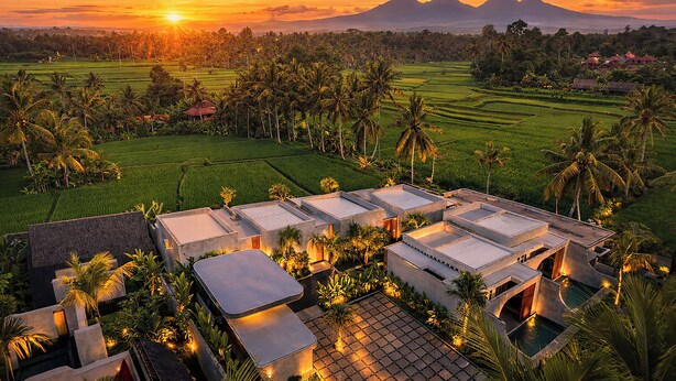 A resort with multiple buildings, a swimming pool, and surrounding lush greenery. - Subu Utamas Villas (Payangan)