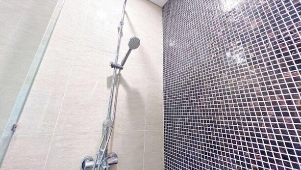 A shower with a glass door and a tiled wall. - D’Rapport by Manhattan Group (Ampang)